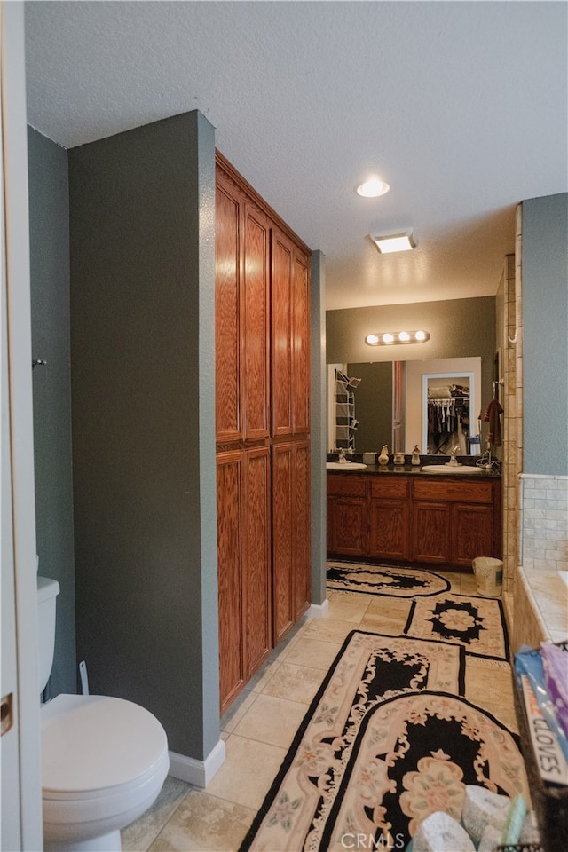 bathroom with vanity, toilet, and tile patterned floors