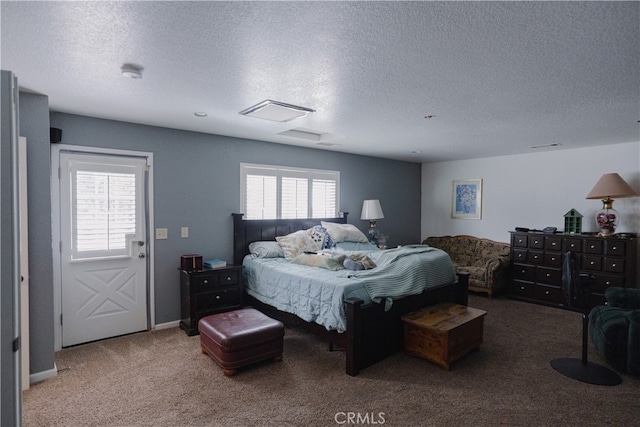 carpeted bedroom with a textured ceiling