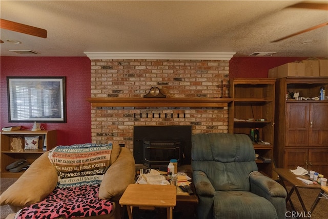 living room with a brick fireplace, a textured ceiling, and crown molding