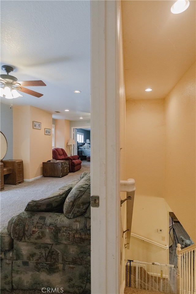 interior space with ceiling fan and carpet flooring