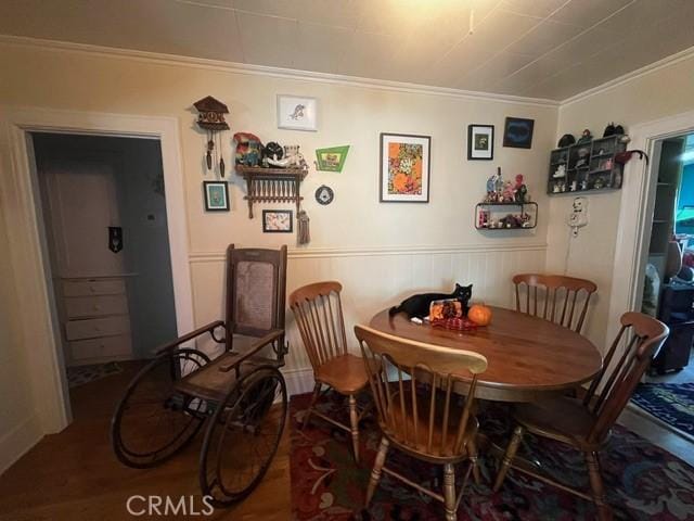 dining area featuring hardwood / wood-style floors and ornamental molding