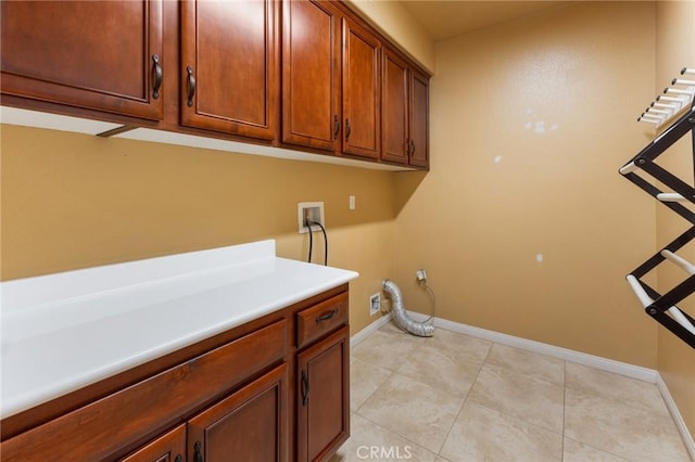 laundry room featuring cabinets, hookup for a washing machine, and light tile patterned floors