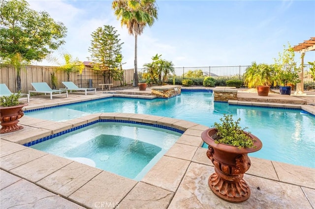 view of pool featuring a patio area, an in ground hot tub, and pool water feature