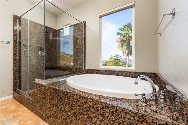 bathroom featuring shower with separate bathtub and a healthy amount of sunlight