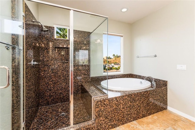 bathroom featuring tile patterned flooring, independent shower and bath, and a healthy amount of sunlight