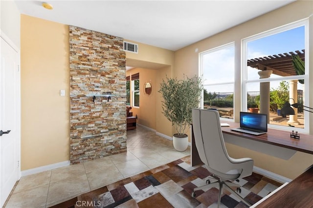 office space featuring light tile patterned floors and built in desk