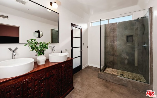 bathroom with vanity and a shower with shower door