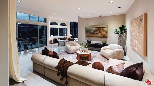 living room featuring a fireplace and light tile patterned flooring