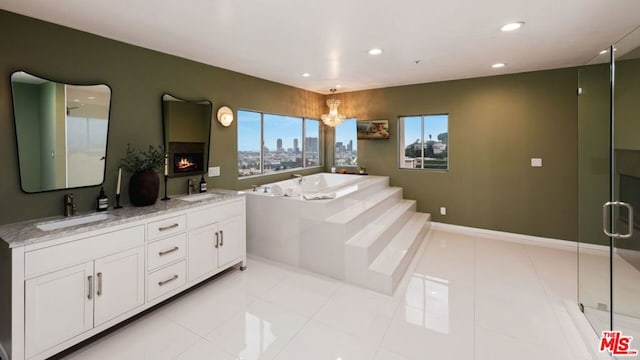 bathroom with tile patterned flooring, vanity, separate shower and tub, and a chandelier