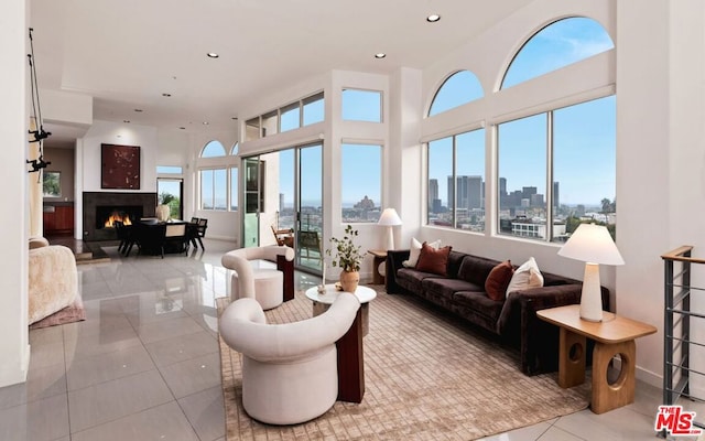 tiled living room featuring a high ceiling