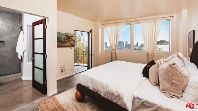 bedroom featuring concrete flooring and access to exterior