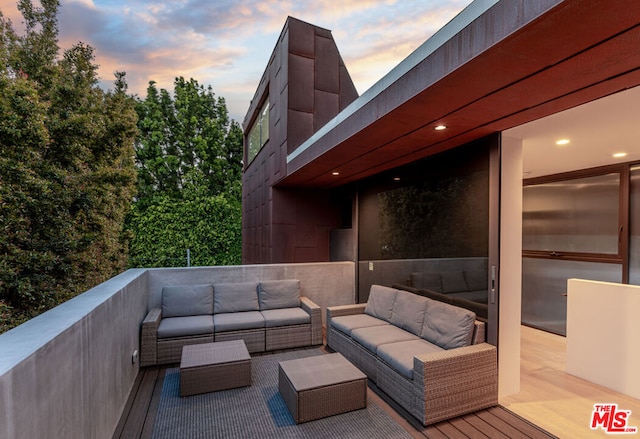 deck at dusk featuring an outdoor living space