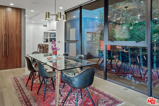 dining space with wood-type flooring