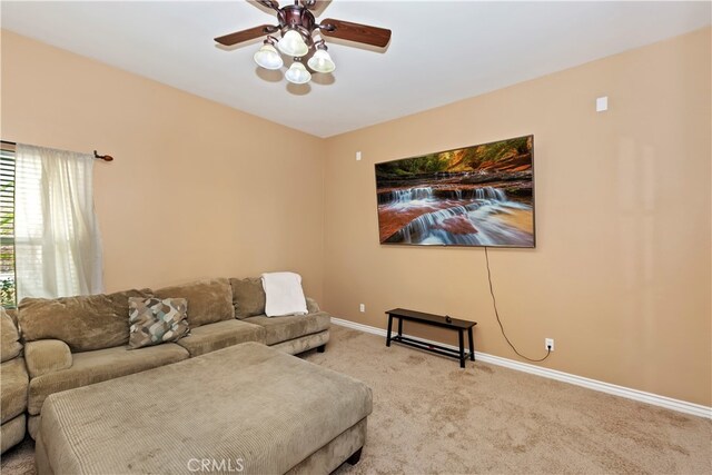 carpeted living room with ceiling fan