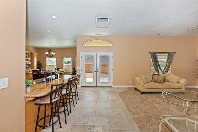 interior space featuring an inviting chandelier and french doors