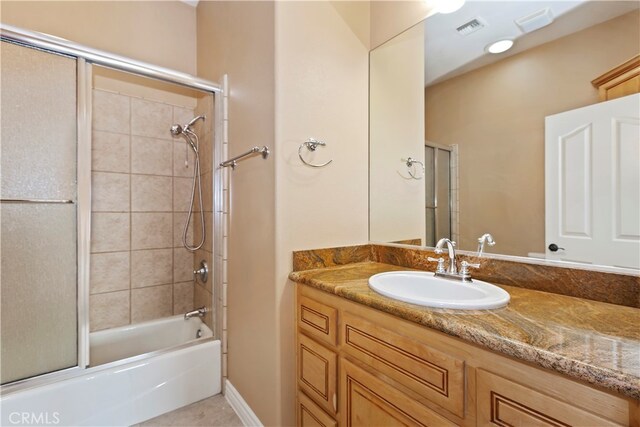 bathroom featuring vanity and enclosed tub / shower combo