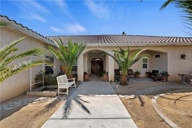 entrance to property with a patio