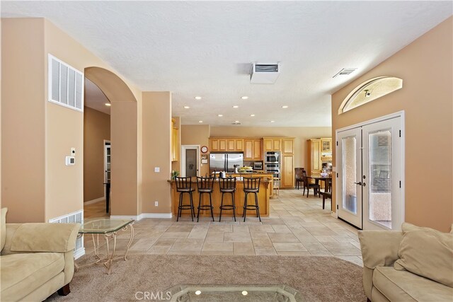 living room featuring a textured ceiling and french doors