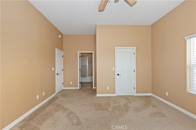 unfurnished bedroom featuring ceiling fan and light colored carpet