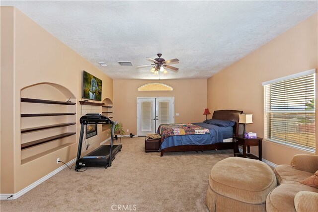 carpeted bedroom featuring a textured ceiling, ceiling fan, and french doors