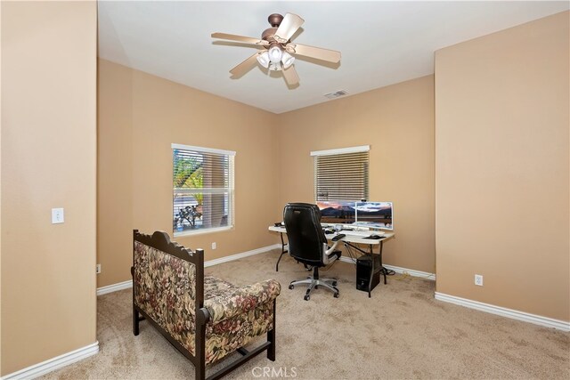 office space with light carpet and ceiling fan