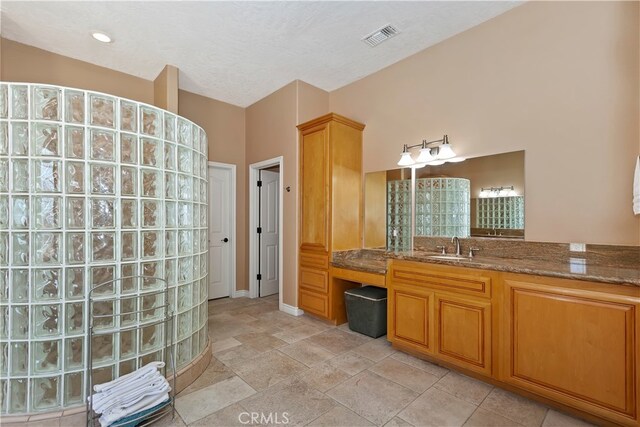 bathroom with vanity and a textured ceiling