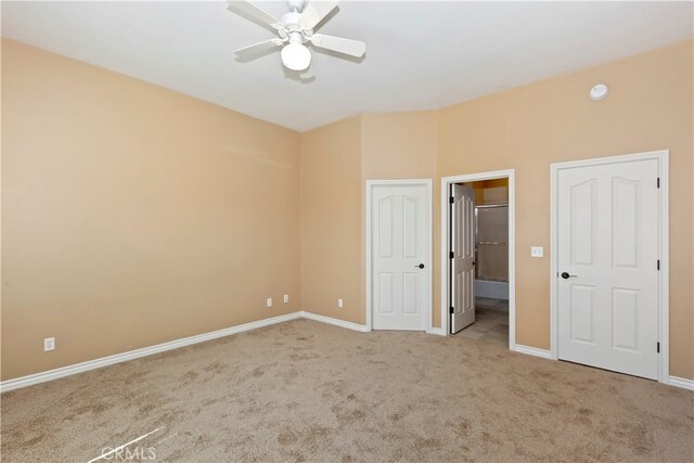 interior space featuring ceiling fan and light colored carpet