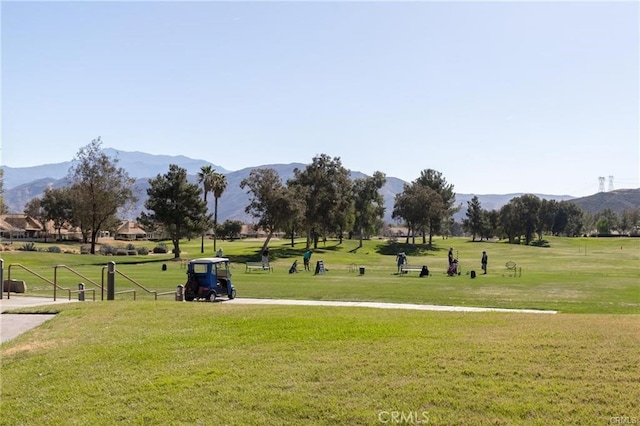 view of property's community featuring a mountain view and a lawn