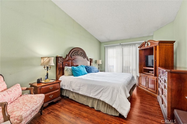 bedroom featuring vaulted ceiling, dark wood-type flooring, and a textured ceiling