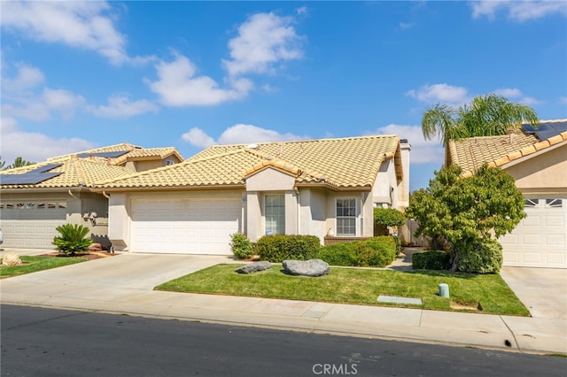 mediterranean / spanish-style house with driveway, an attached garage, and stucco siding