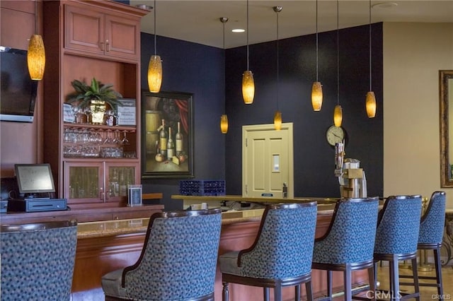 bar featuring pendant lighting and indoor wet bar