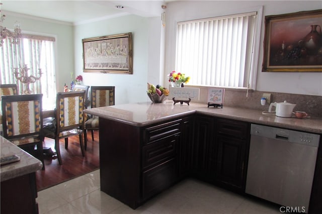 kitchen with kitchen peninsula, light stone countertops, light tile patterned floors, stainless steel dishwasher, and ornamental molding