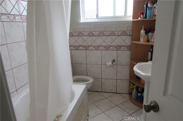 bathroom with tile walls, toilet, separate shower and tub, and tile patterned floors