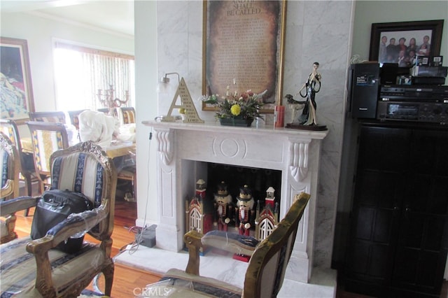 living room featuring wood-type flooring and crown molding