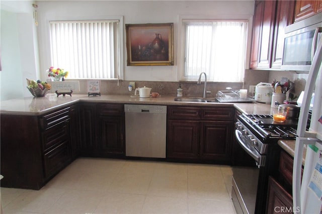 kitchen with light tile patterned floors, appliances with stainless steel finishes, and sink