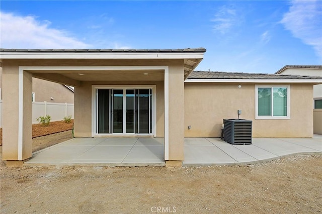 rear view of house featuring a patio and central AC