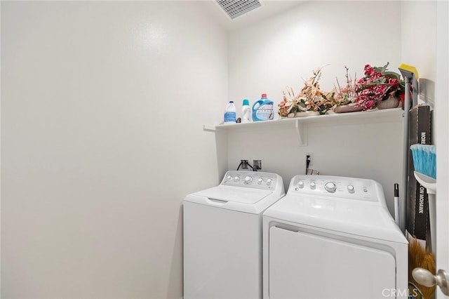 clothes washing area featuring washer and clothes dryer