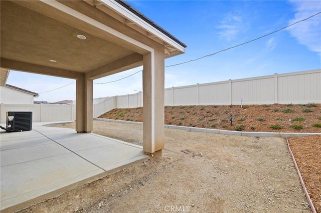 view of yard with a patio and central AC