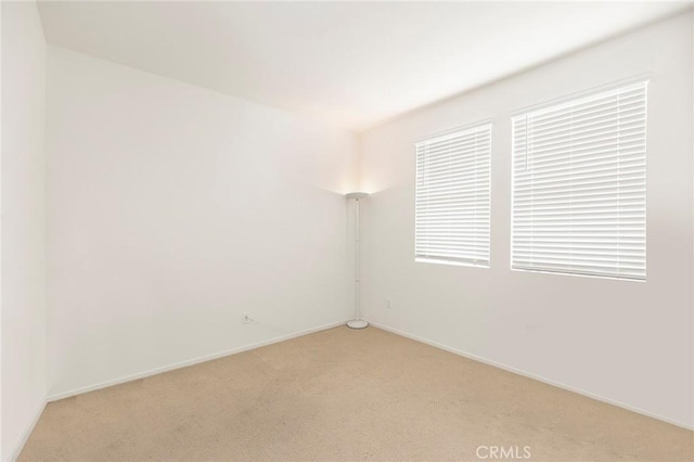 unfurnished room with light carpet