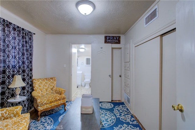 living area featuring a textured ceiling