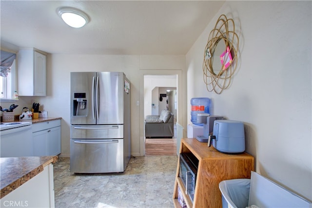 kitchen featuring white cabinetry and stainless steel fridge with ice dispenser