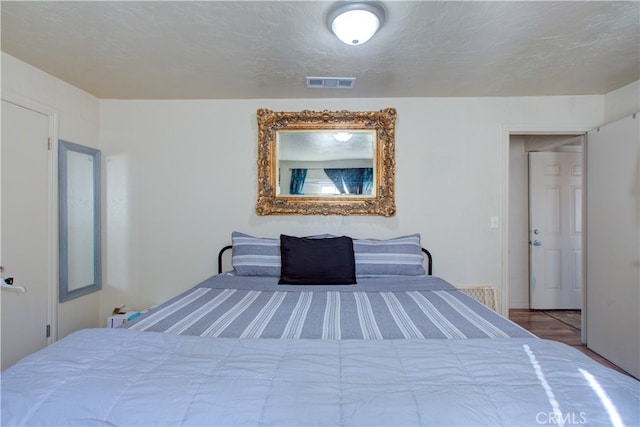 unfurnished bedroom featuring a textured ceiling and light hardwood / wood-style flooring