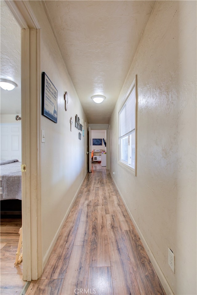 hallway with wood-type flooring