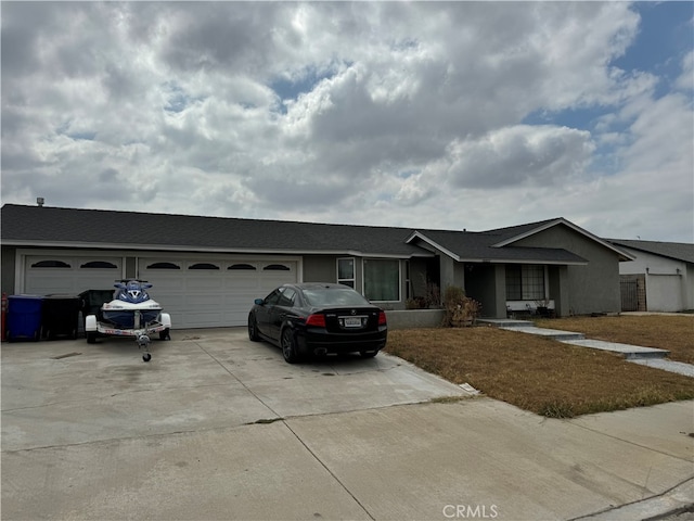 single story home with a garage and a front lawn