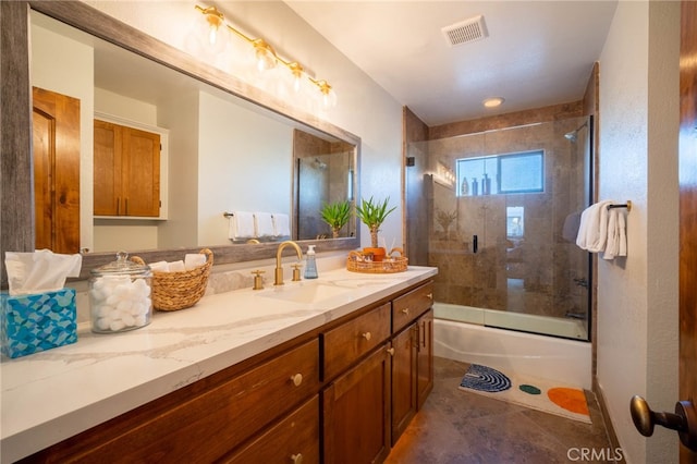 bathroom featuring enclosed tub / shower combo, tile patterned flooring, and vanity