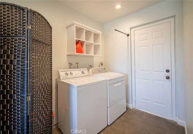 laundry area featuring washer and clothes dryer and carpet