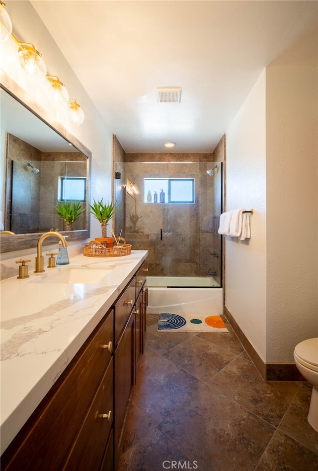 full bathroom with shower / bath combination with glass door, vanity, and toilet