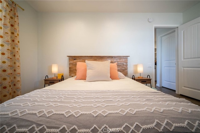 bedroom featuring a closet and dark wood-type flooring