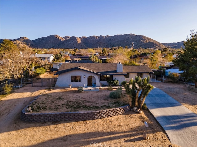 ranch-style home featuring a mountain view