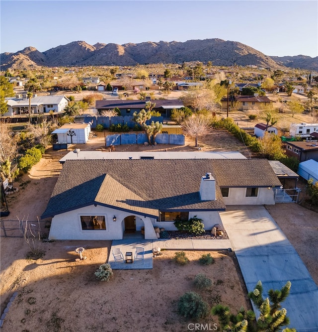 birds eye view of property with a mountain view